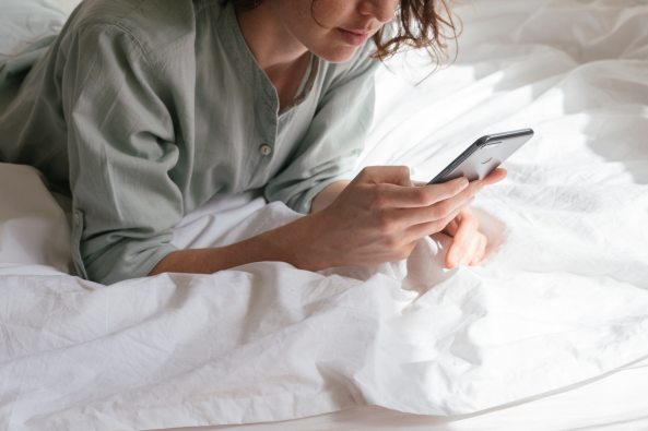 woman-using-smartphone-in-bed-3060643